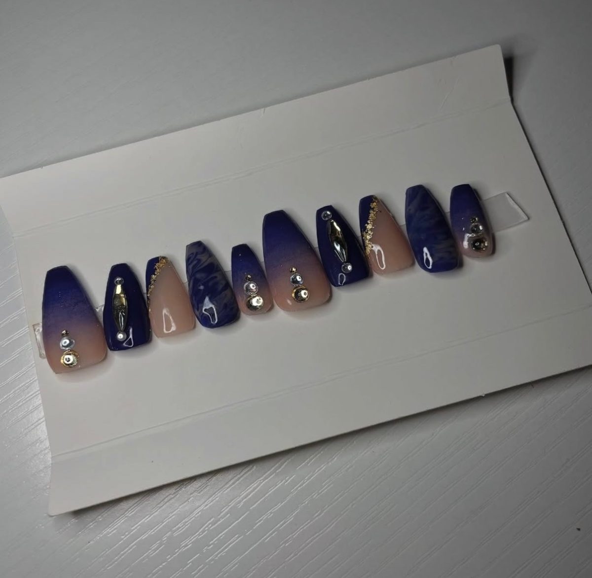Elegant blue and gold nails with silver gems